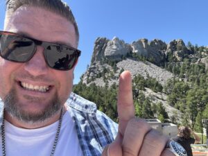 Pointing at Mt Rushmore