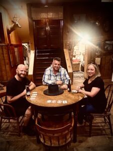 2 guys and 1 girl sitting at a poker table in Deadwood, SD