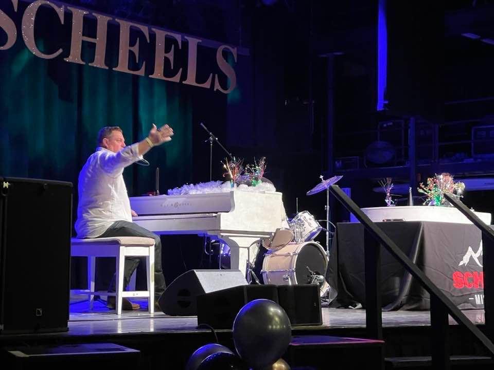 Papi Sorrels entertains a crowd with dueling pianos for Scheels party.